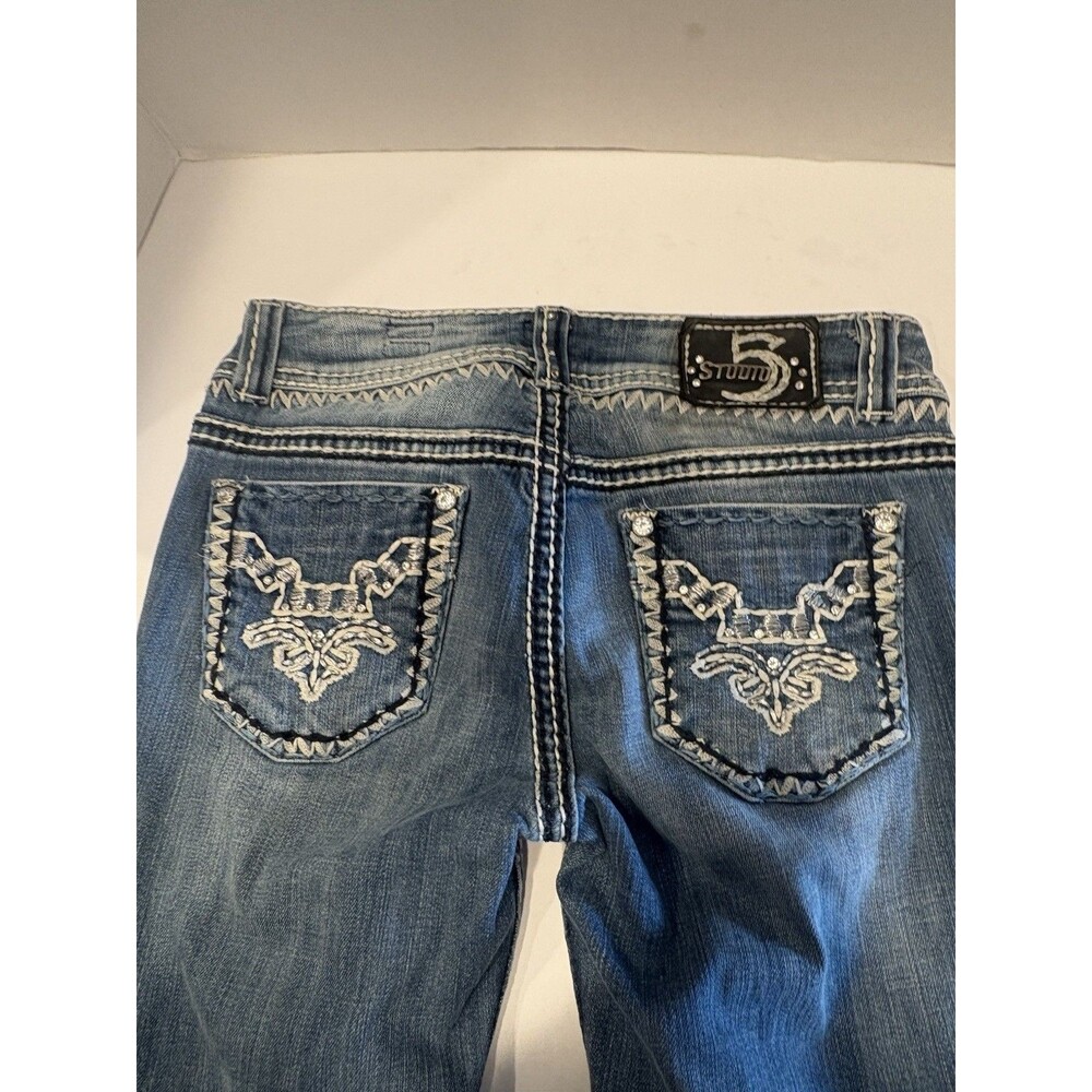 Studio 5 embellished Y2K-style blue denim jeans featuring signature